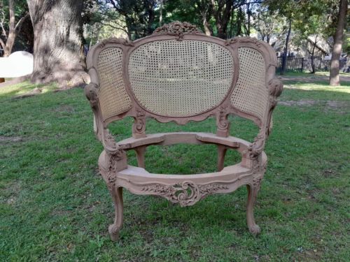 A 20TH Century French Style Bergere Style Carved Rattan Chair in a Contemporary Natural Wood Finish