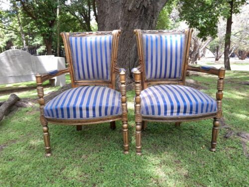 A Pair Of 20th Century French Louis XVI Styled Ornately Carved And Gilded Arm Chairs