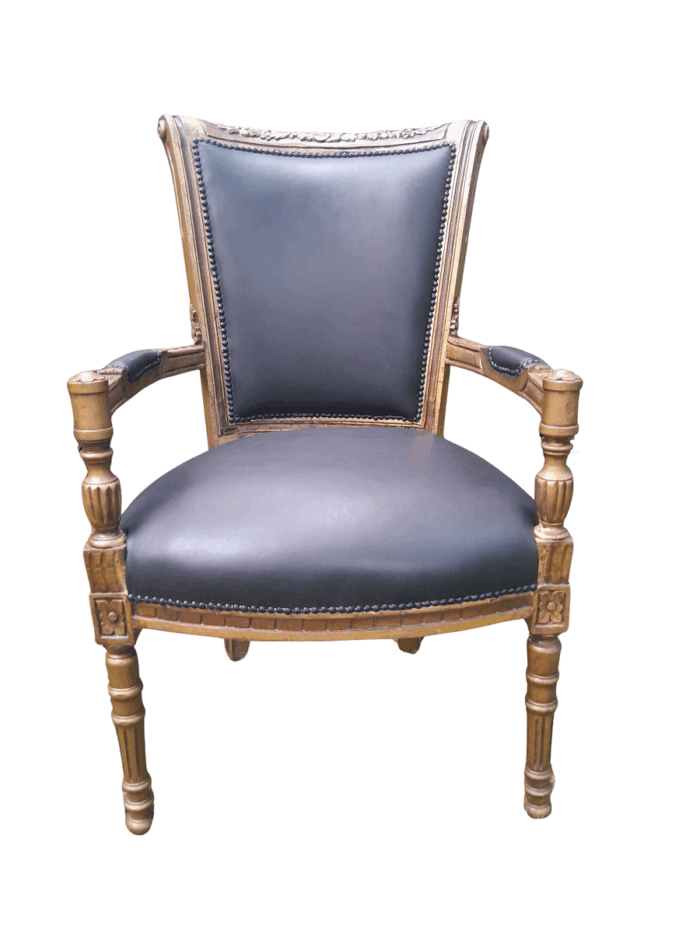 A 20th Century French Louis XVI Styled Ornately Carved And Gilded Arm Chair upholstered in black leather