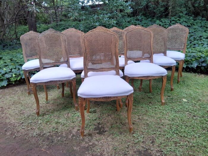 A Rare 20th Century Set Of Twelve French Colonial Style Walnut Rattan Dining Chairs - Image 2