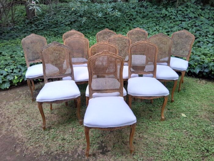 A Rare 20th Century Set Of Twelve French Colonial Style Walnut Rattan Dining Chairs - Image 3