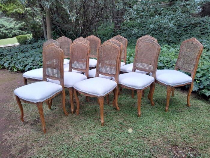 A Rare 20th Century Set Of Twelve French Colonial Style Walnut Rattan Dining Chairs - Image 4