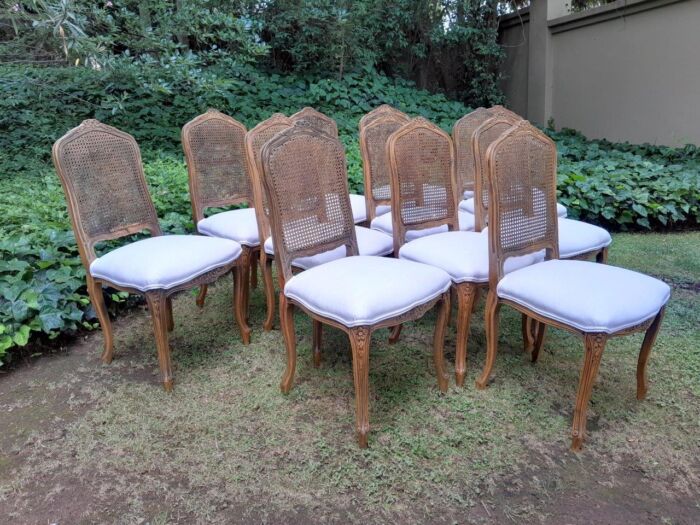 A Rare 20th Century Set Of Twelve French Colonial Style Walnut Rattan Dining Chairs - Image 5
