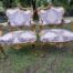 A 20th Century Pair Of French Rococo Style Ornately Carved Wooden Gilt-Wood Arm Chairs