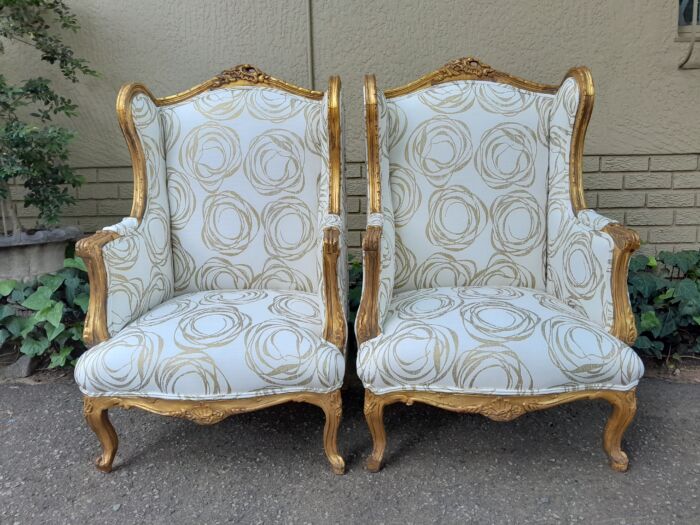 A French Style Pair of Hand Gilded Carved Wingback Chairs Upholstered in a Custom Made for The Crown Collection Cotton / Linen Fabric - Image 2