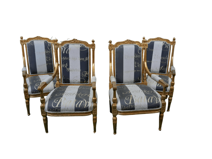 A French Style Set Of Four Ornately Carved And Gilded Armchairs In A Custom-Made Stripe And Script Linen (Also Sold As Pairs SKU 3109)