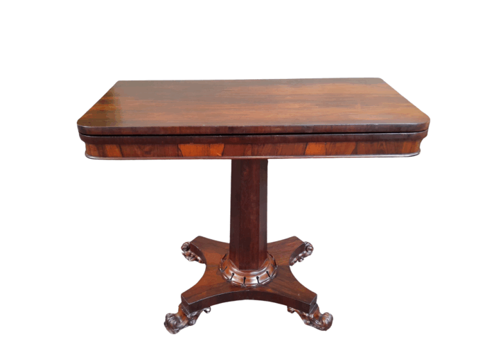 A Victorian rosewood swivel and tilt Card Table, on spreading hexagonal column to the concave platform base on knurl feet with castors