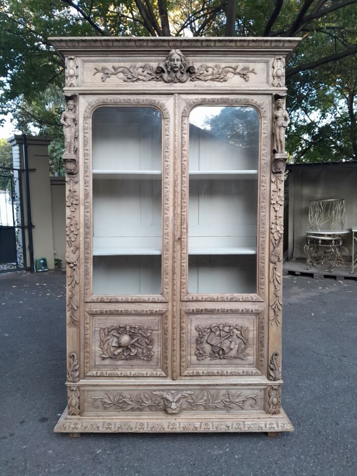 An Antique 19th Century Circa 1880 Large Renaissance-Revival European Oak Carved Bookcase / Cabinet With Glazed Glass Doors in a Contemporary Natural / Bleached Finish - Image 3