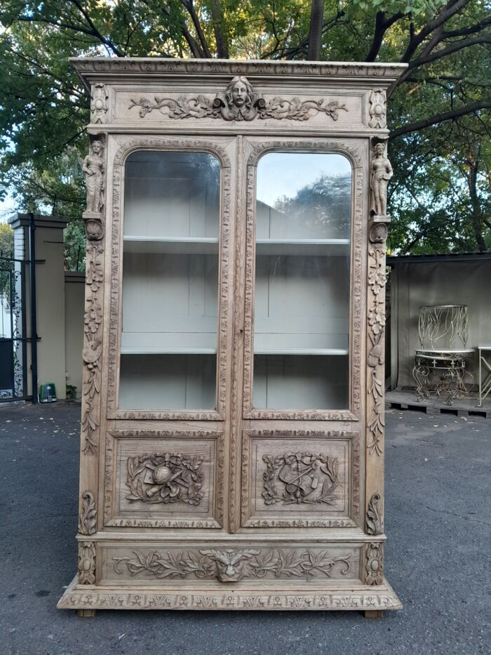 An Antique 19th Century Circa 1880 Large Renaissance-Revival European Oak Carved Bookcase / Cabinet With Glazed Glass Doors in a Contemporary Natural / Bleached Finish - Image 2