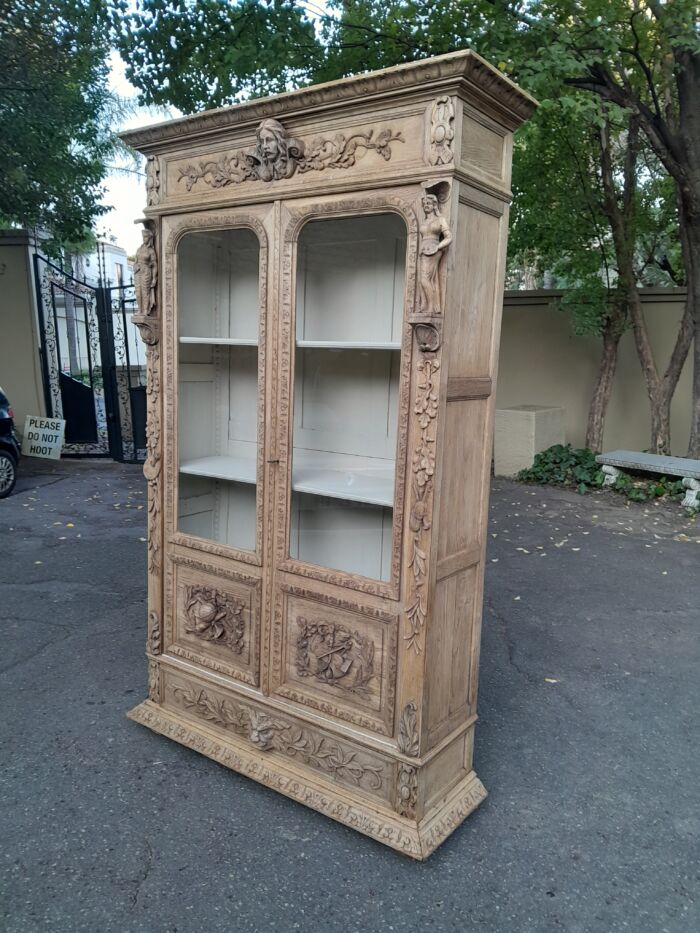 An Antique 19th Century Circa 1880 Large Renaissance-Revival European Oak Carved Bookcase / Cabinet With Glazed Glass Doors in a Contemporary Natural / Bleached Finish - Image 5