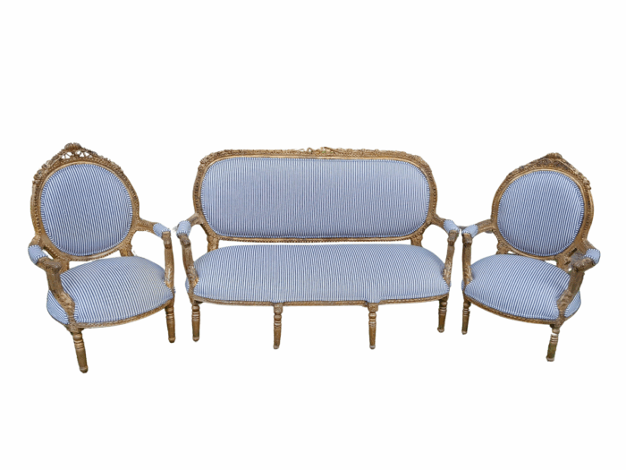 A 20th Century French Style Ornately Carved and Gilded Set Of Settee And a Pair Of Armchairs Upholstered in an Imported Fabric
