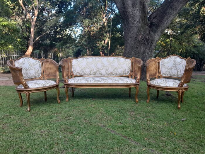 A Mid 20th Century Circa 1950 French Set Of Gilt Painted Wooden And Rattan Settee With A Pair Of Bergère Chairs Upholstered In A Custom Made Linen For The Crown Collection - Image 2