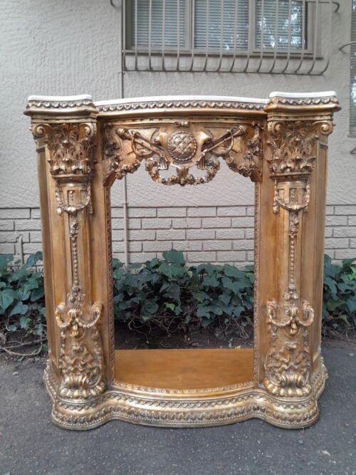 A 20TH Century French Style Ornately Hand Carved and Gilded Fireplace Surround