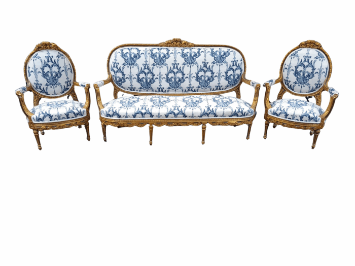 A 20TH Century French Louis XVI Style Set Of A Carved And Gilded Settee And Pair Of Armchairs