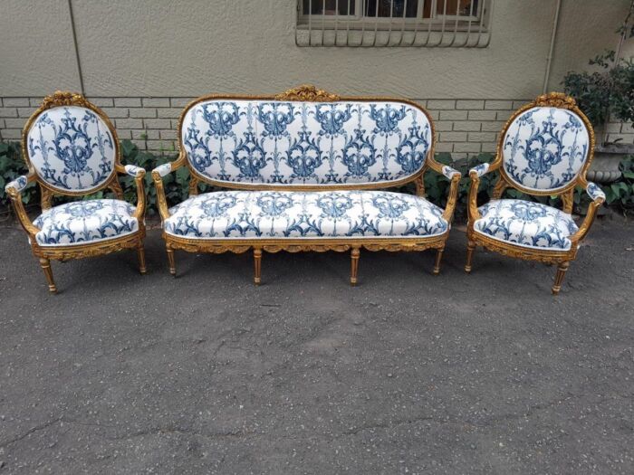A 20TH Century French Louis XVI Style Set Of A Carved And Gilded Settee And Pair Of Armchairs - Image 2