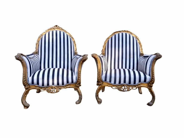 A 20th Century Pair of French Style Louis XVI Style Ornately Carved and Gilded Armchairs