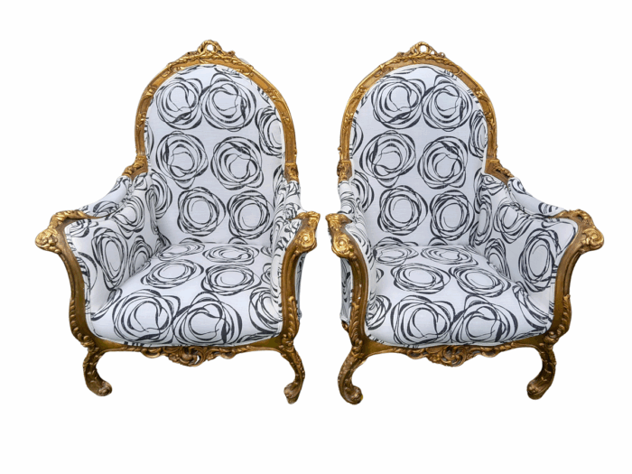 A 20th Century Pair of French Style Louis XVI Style Ornately Carved and Gilded Armchairs Upholstered in a Charcoal Linen/Cotton Blend Fabric