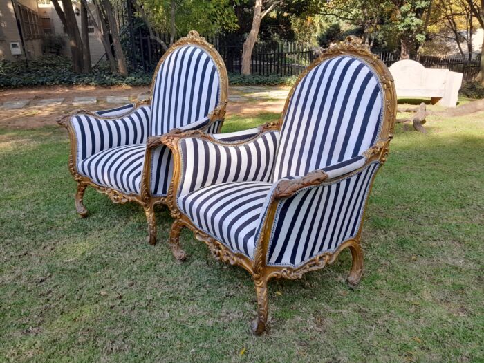 A 20th Century Pair of French Style Louis XVI Style Ornately Carved and Gilded Armchairs - Image 6