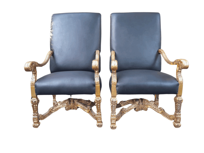 A 20th Century French Style Carved and Giltwood Arm Chairs Upholstered in Leather)