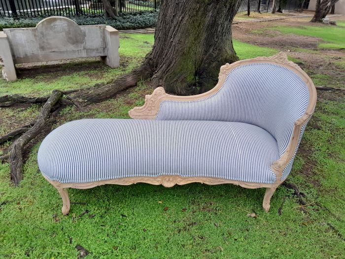 A 20th Century French Style Ornately Carved Chaise Longue in a Contemporary Bleached Finish and Upholstered in Ticking Fabric - Image 3