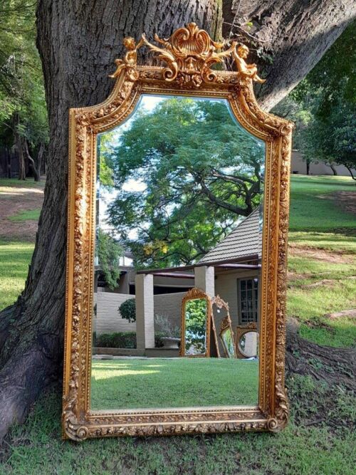 A French Style Ornately Carved and Gilded Bevelled Mirror