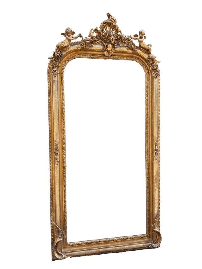 A French Style Ornately Carved And Gilded Bevelled Mirror