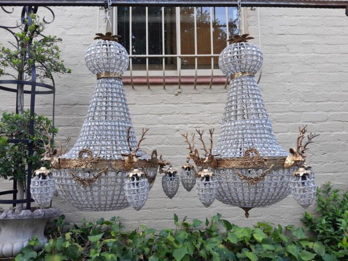 A French Style Pair of Aged Brass Pair of Monumental Empire Style Chandeliers with Deer Head Figures