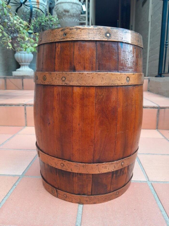 An Antique Teak and Brass Belted Machanick Co Wine Barrel