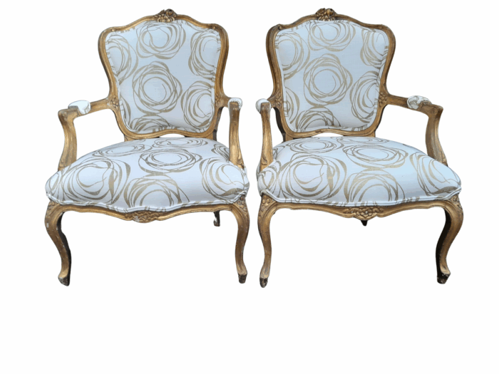 A 19th Century Pair of French Carved and Gilded Wooden Armchairs Upholstered in a Custom Made Fabric for The Crown Collection 