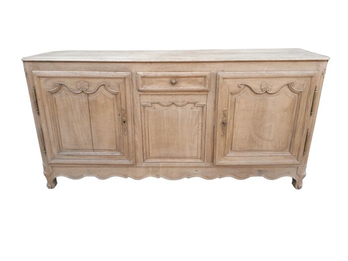 A 19th Century  Circa 1870 Carved Oak Side Board / Server With Drawer and Doors with Brass Mounts with Lock and Key in a Contemporary Bleached / Natural finish