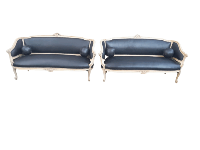 A 20th Century Pair of French Style Carved Walnut Settees in a Contemporary Bleached Finish and Upholstered in Leather with One Leather Decorative Ball Per Settee