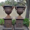 A 20TH Century Pair of French Cast Iron Urns / Planters on Plinths of Large Proportions
