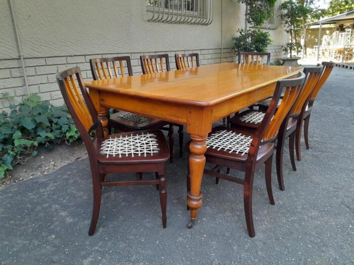 A Late 19thCentury  Early 20th Century Yellowwood Dining Table  with A 20th Century Set of Eight (8) Cape Stinkwood and Yellowwood Riempie Dining Chairs - Image 3