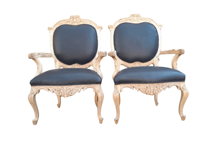 A 20th Century Pair Of French Style Carved Oak Armchairs In A Contemporary Bleached Finish And Upholstered In Leather