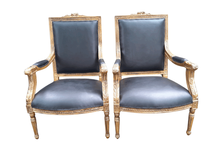 A 20th Century French Style Pair of Carved Gilt-Wood Arm Chairs Upholstered in Black Leather