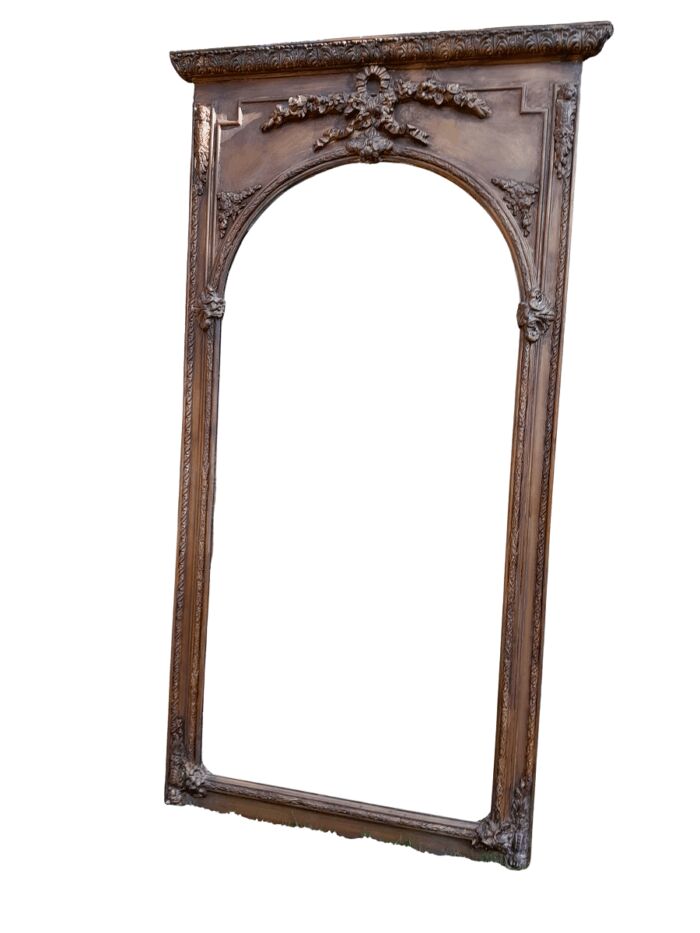 A French Style Ornately Carved And Gilded Bevelled Mirror Of Large Proportions