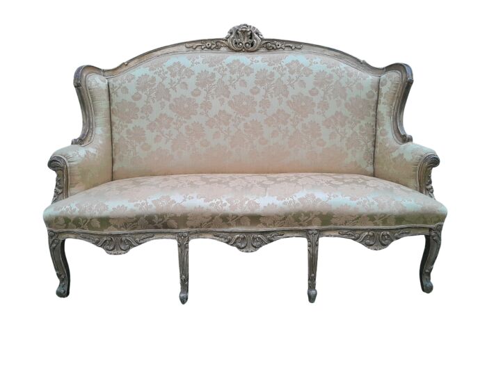 An Early 20th Century French Style Ornately Carved and Gilded Wingback Settee 