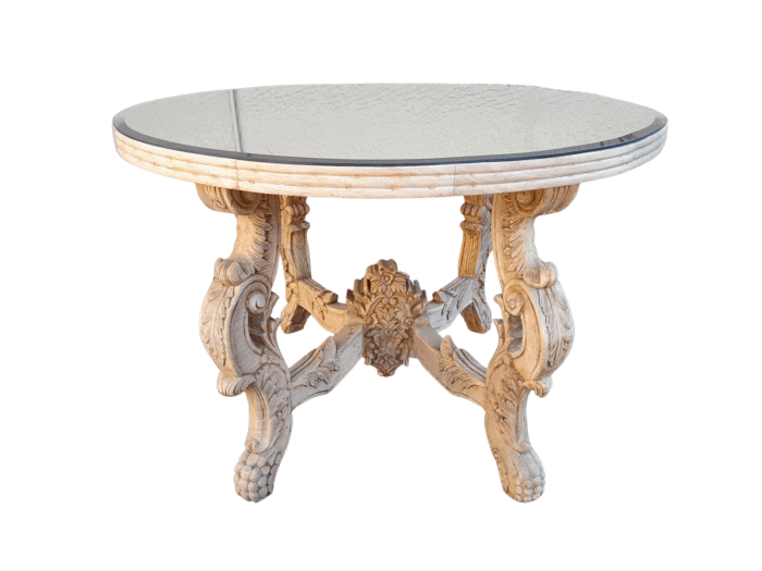 A 20th Century Ornately Carved Circular Wooden Table In A Contemporary Bleached Finish And With A Bevelled Mirror Top