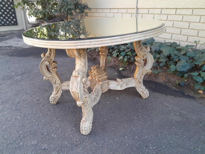 A 20th Century Ornately Carved Circular Wooden Table In A Contemporary Bleached Finish And With A Bevelled Mirror Top - Image 4