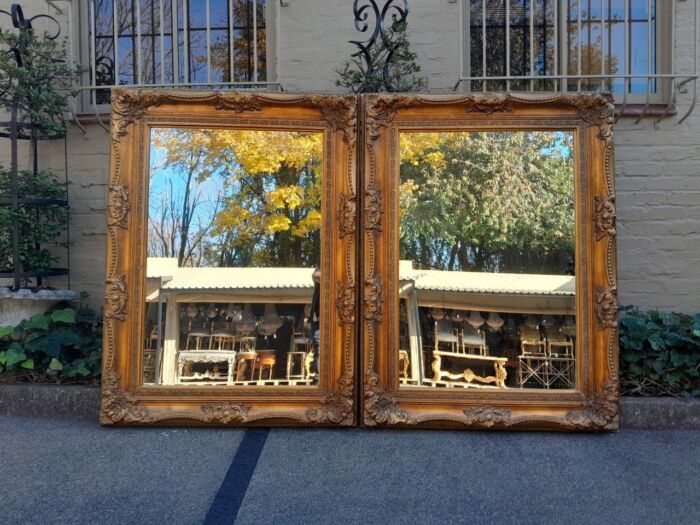 A 20th Century French Style Pair of Large and Ornately Carved Giltwood Mirrors - Image 2