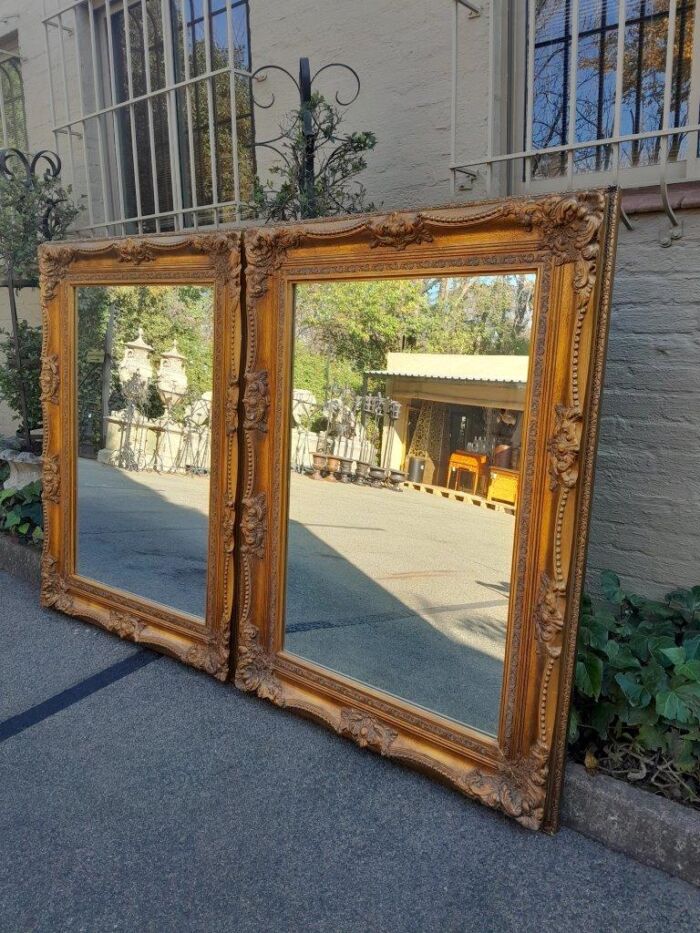 A 20th Century French Style Pair of Large and Ornately Carved Giltwood Mirrors - Image 5