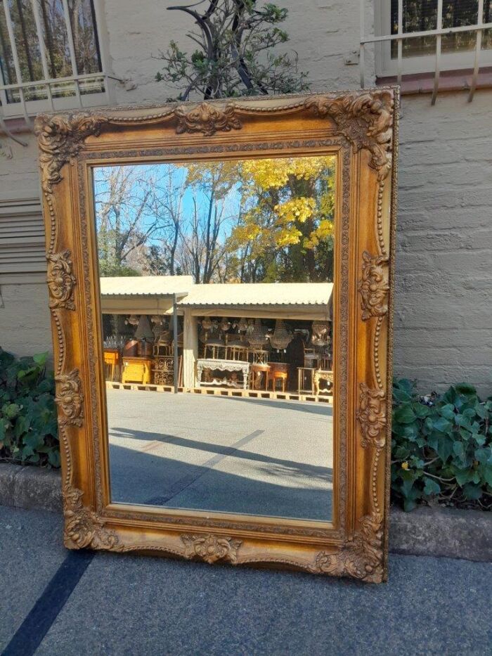 A 20th Century French Style Pair of Large and Ornately Carved Giltwood Mirrors - Image 8