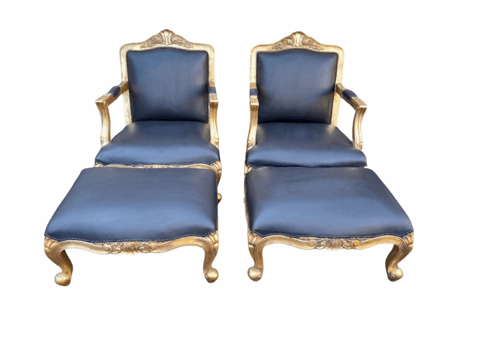 A 20th Century Near Pair  Of Victorian Style Hand-Gilded Mahogany Armchairs And Ottomans Upholstered In Leather