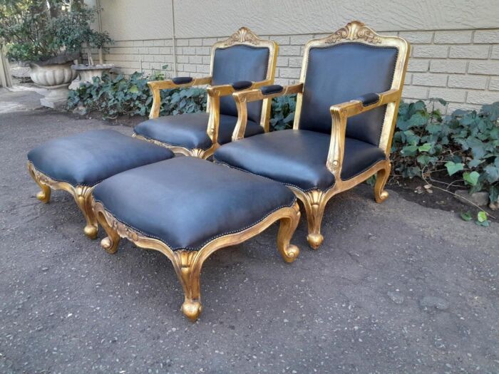 A 20th Century Near Pair  Of Victorian Style Hand-Gilded Mahogany Armchairs And Ottomans Upholstered In Leather - Image 2