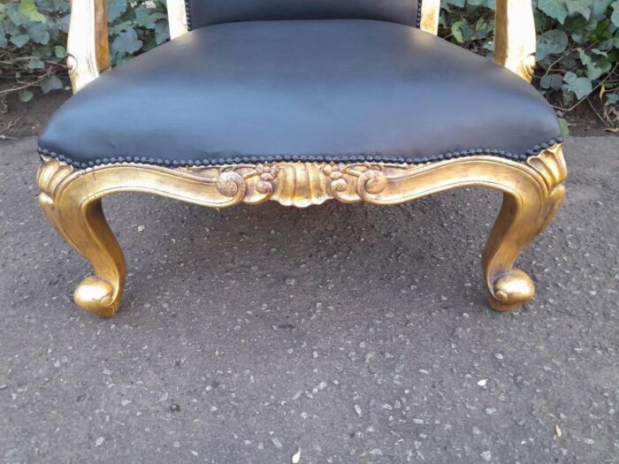 A 20th Century Near Pair  Of Victorian Style Hand-Gilded Mahogany Armchairs And Ottomans Upholstered In Leather - Image 6