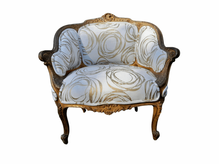 A Late 19th Century French Carved and Gilt Wood Walnut Bergere Armchair  Upholstered in  a custom made fabric for The Crown Collection