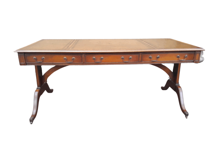 A 20th Century Victorian Style Mahogany Library Desk With  Original Gilt Tooled Leather Inserts On Castors