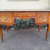 A 20th Century French Style Mahogany And Mahogany Marquetry Inlaid Desk With Brass Caps And Drawers