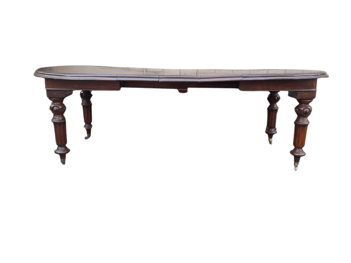 A 19th Century Antique Victorian Mahogany Extending Dining Table with Heavily Carved Legs on Brass Castors