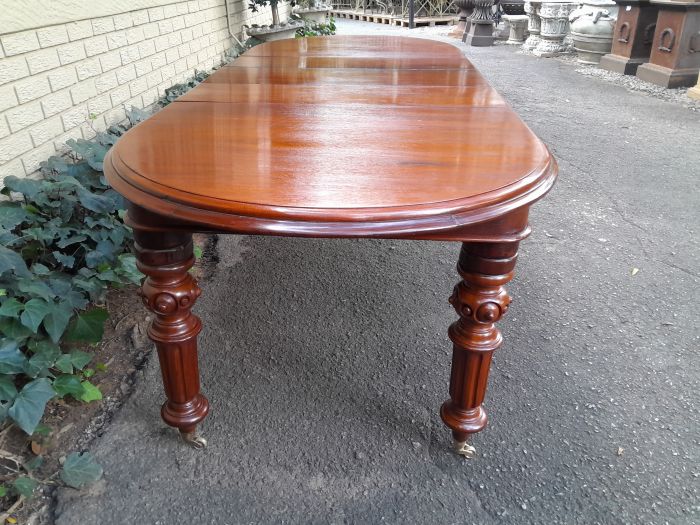 A 19th Century Antique Victorian Mahogany Extending Dining Table with Heavily Carved Legs on Brass Castors - Image 5